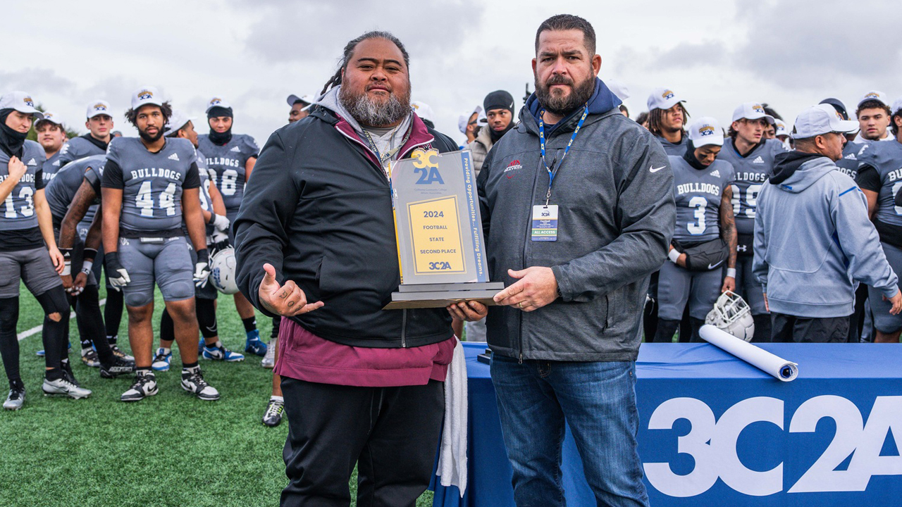 Mt. SAC assistant coach Bobby Purcell accepts the 3C2A State Championship second place trophy. (Photo by Leroy Lau)